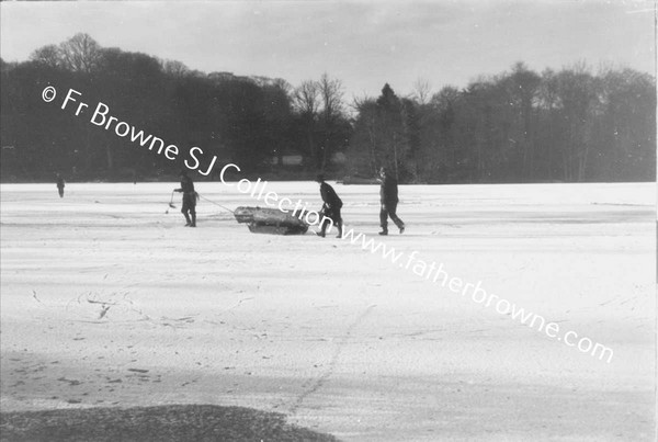 TAKING LOG ACROSS FROZEN LAKE